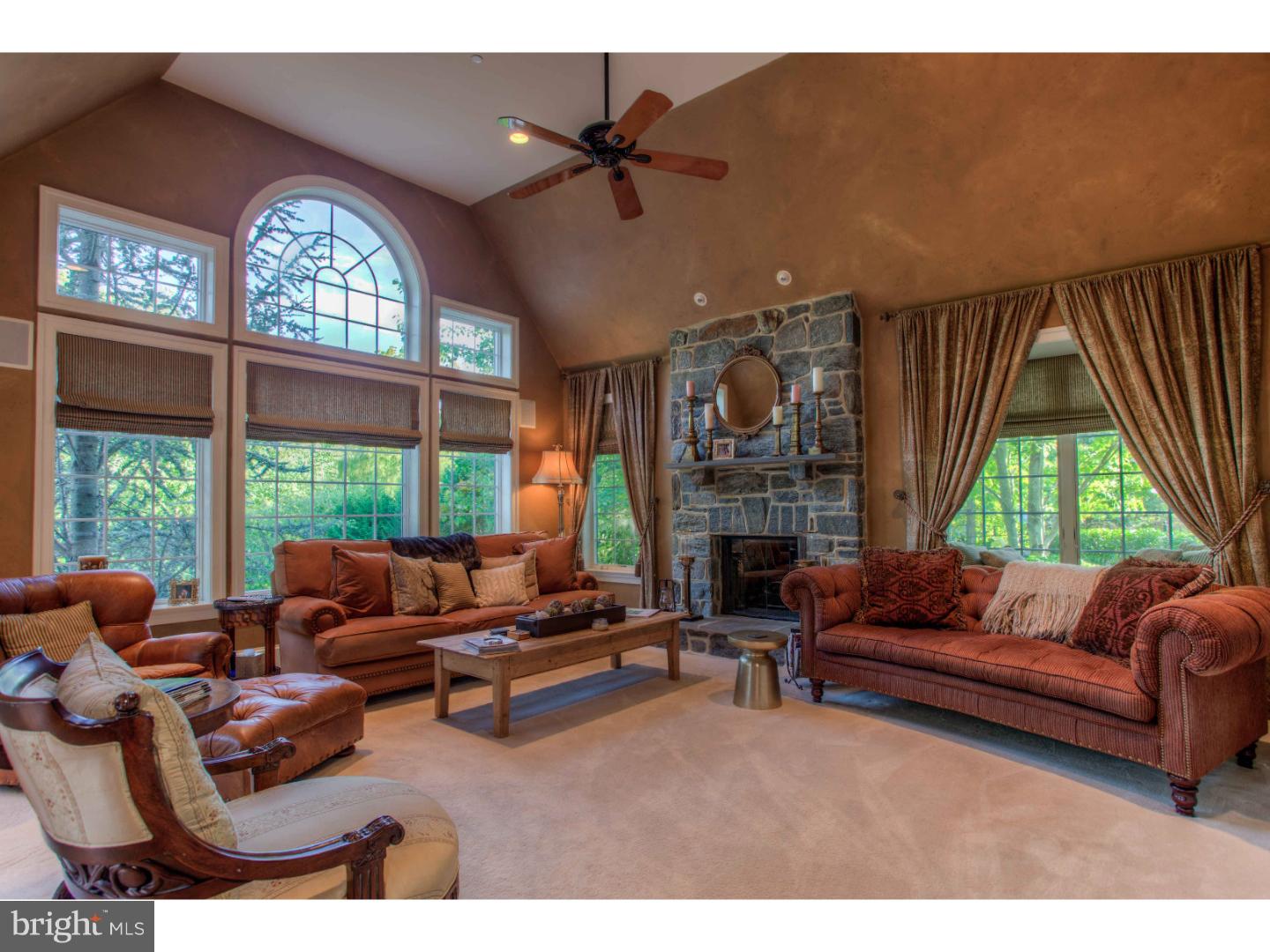 1033 Whitegate Road Wayne, PA 19087 - Photo 7 of 23 a living room with furniture a fireplace and a large window