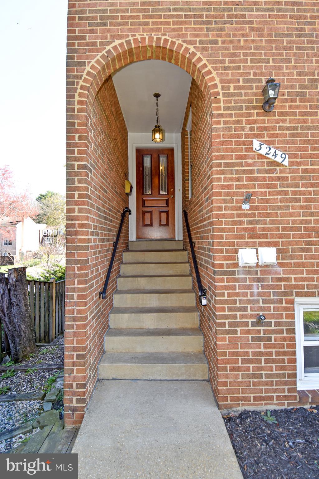3249 Victor Circle Annandale, VA 22003 - Photo 2 of 33 Brick Archway walkup to Custom Wood Door