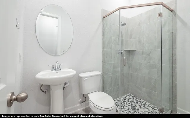 a bathroom with a sink toilet and a mirror