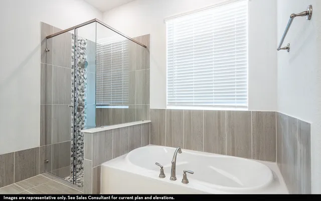 a bathroom with bathtub and shower