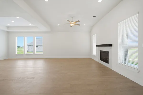 a large kitchen with stainless steel appliances granite countertop a lot of counter space and wooden floors