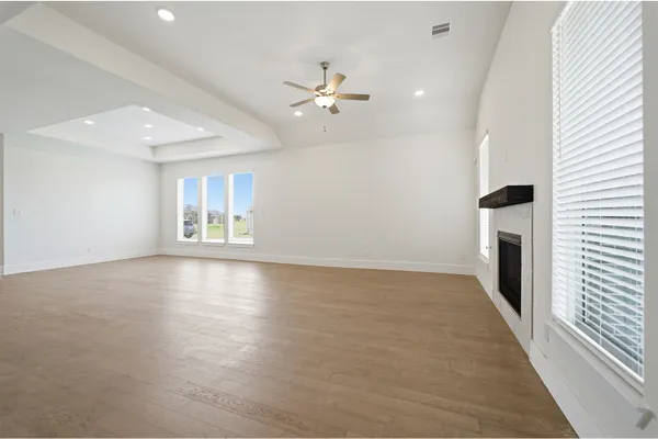 a kitchen with kitchen island a sink stainless steel appliances and white cabinets