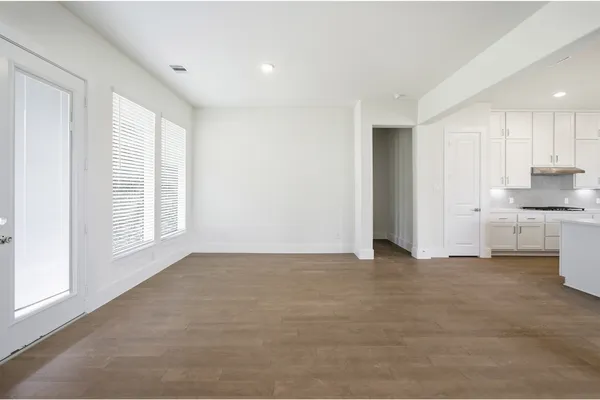 a kitchen with kitchen island a sink stainless steel appliances and white cabinets