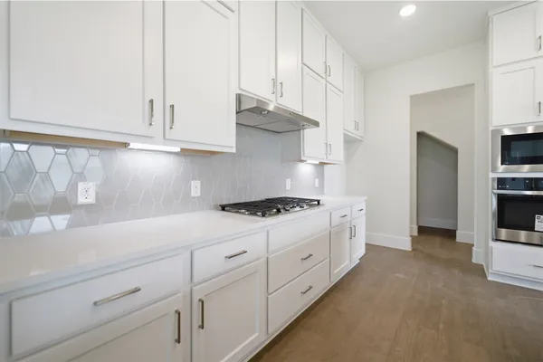 a spacious bathroom with a granite countertop sink mirror and a bathtub