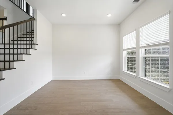 a view of entryway and hall with wooden floor