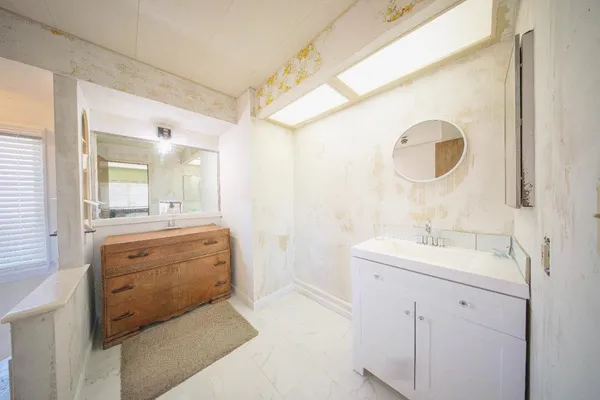 a bathroom with a sink and a mirror