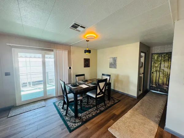 a view of a patio with a table and chairs under an umbrella