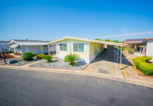 a kitchen with a sink cabinets appliances and a window