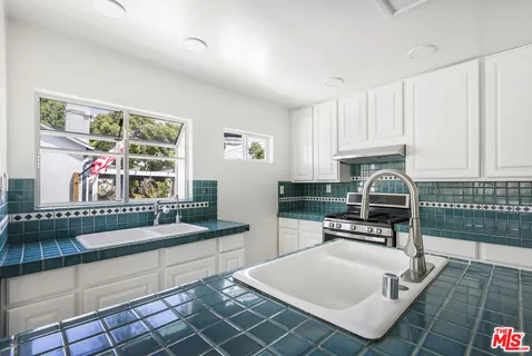 a view of a balcony with wooden floor and iron fence