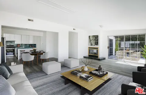 a view of a patio with table and chairs and potted plants