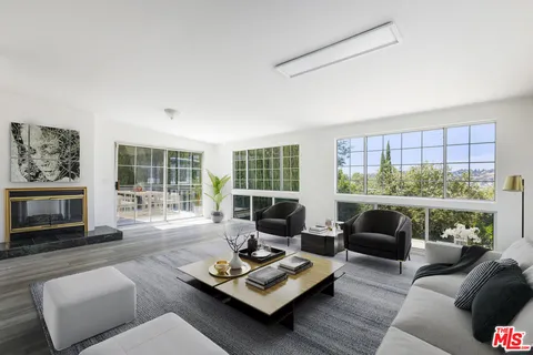 a bedroom with a large bed and a large window