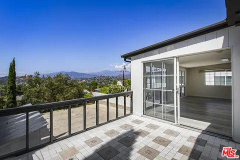 a view of empty room with a fireplace