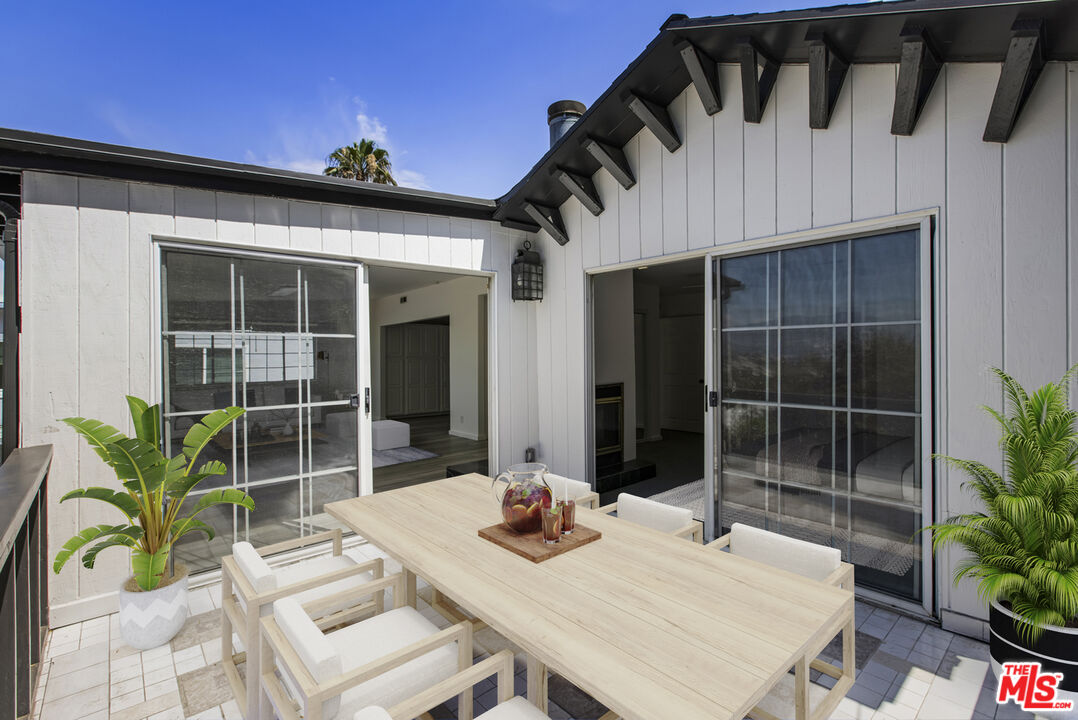 4013 Division Street Los Angeles, CA 90065 - Photo 19 of 66 a view of a patio with table and chairs and potted plants