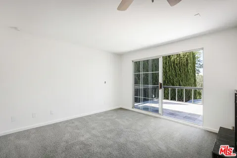 a view of a hallway with wooden floor and stairs