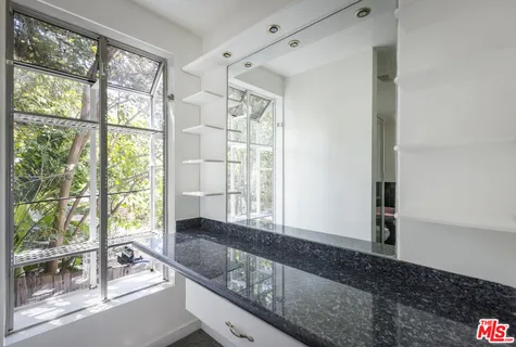 a bedroom with a bed and a night stand