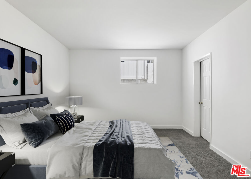 4013 Division Street Los Angeles, CA 90065 - Photo 36 of 66 a bedroom with a bed and wooden floor