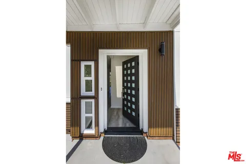 a kitchen with stainless steel appliances granite countertop a sink dishwasher and cabinets with wooden floor