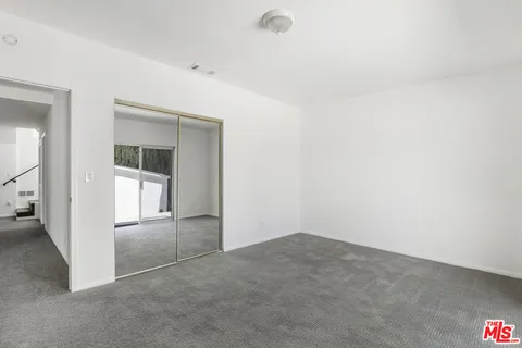 a view of a house with a yard and a car park