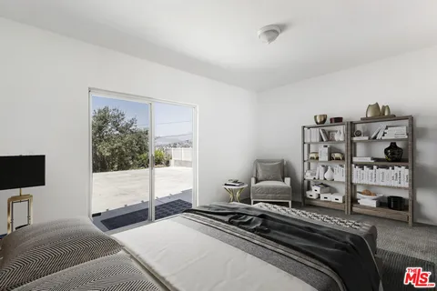 a white house that has a tree in front of it