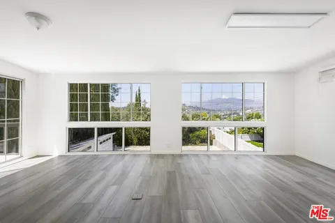 a kitchen with stainless steel appliances granite countertop a sink a refrigerator a counter top space and cabinets