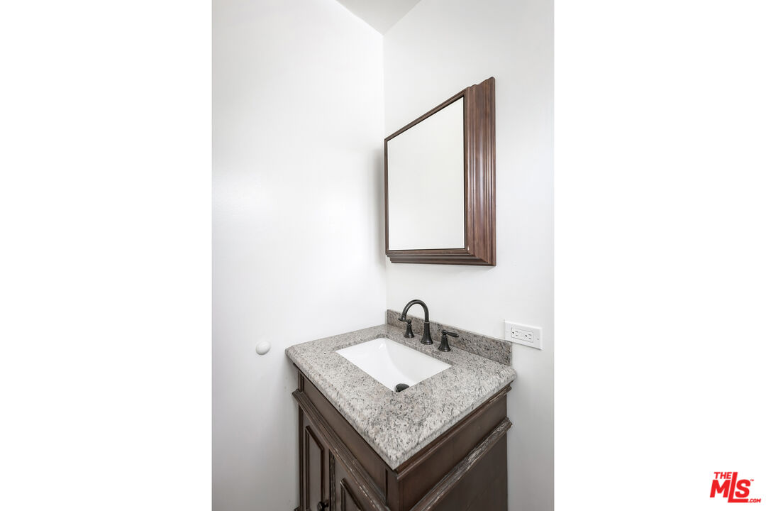 4013 Division Street Los Angeles, CA 90065 - Photo 65 of 66 a bathroom with a granite countertop sink and a mirror
