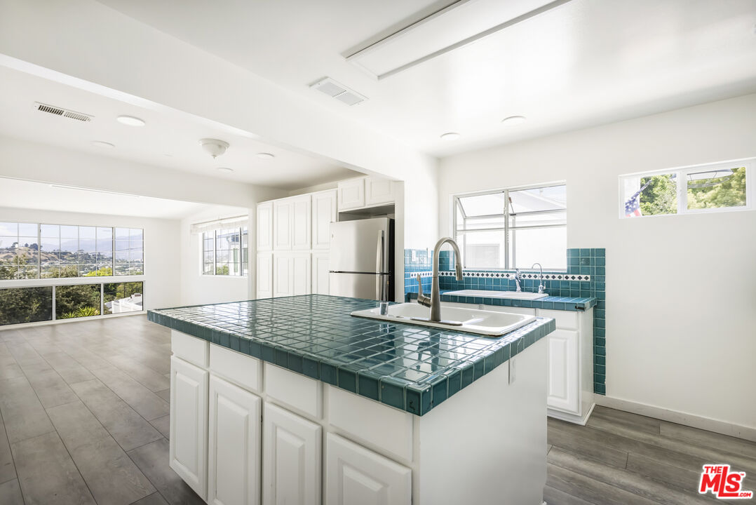 4013 Division Street Los Angeles, CA 90065 - Photo 7 of 66 a kitchen with stainless steel appliances granite countertop a sink dishwasher and cabinets with wooden floor