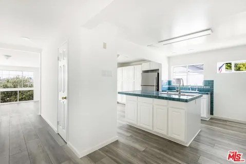 a kitchen with stainless steel appliances a stove a sink and a microwave