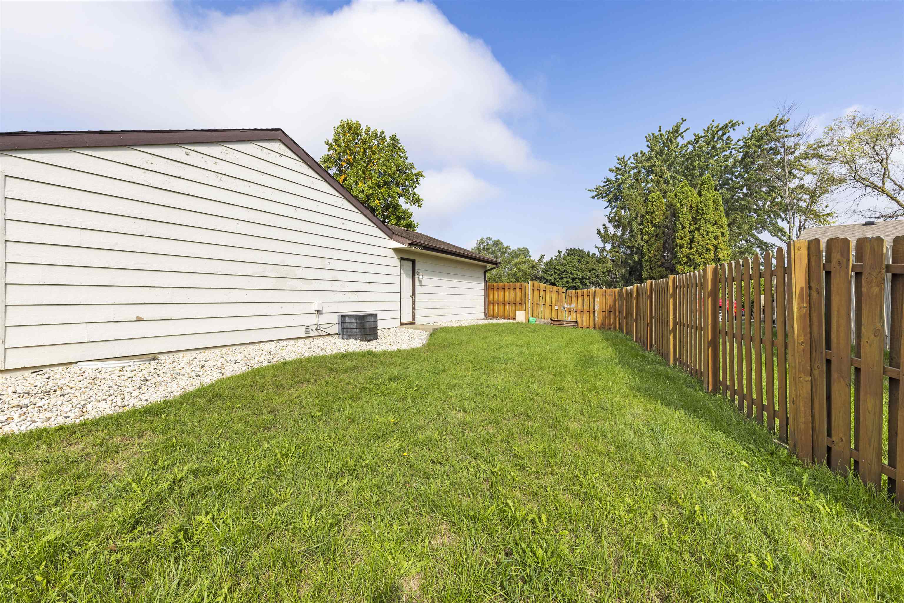 4031 Fairfax Road Roscoe, IL 61073 - Photo 20 of 23 a view of a backyard with wooden fence