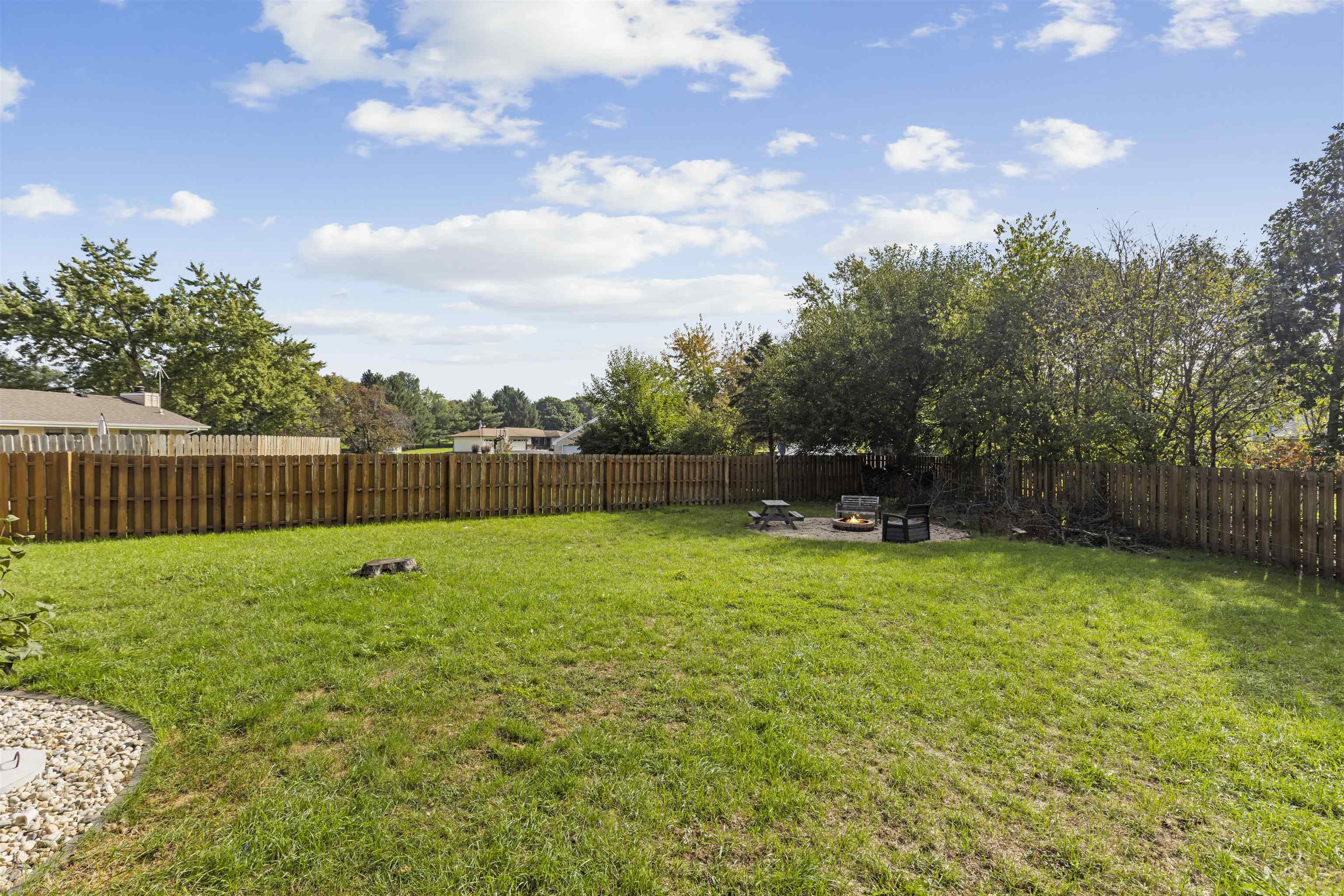 4031 Fairfax Road Roscoe, IL 61073 - Photo 21 of 23 a view of a backyard with a garden and entertaining space