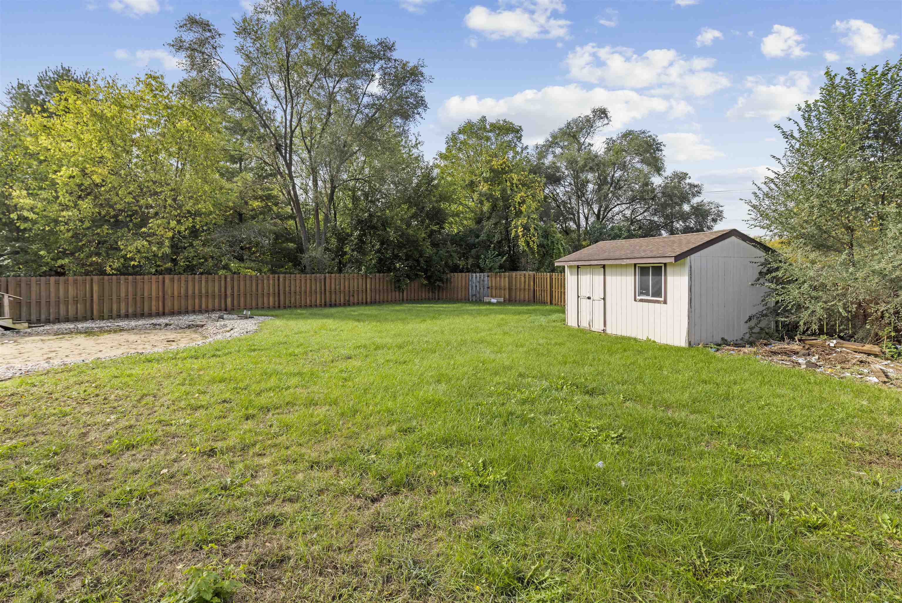 4031 Fairfax Road Roscoe, IL 61073 - Photo 22 of 23 a view of a backyard with a small cabin