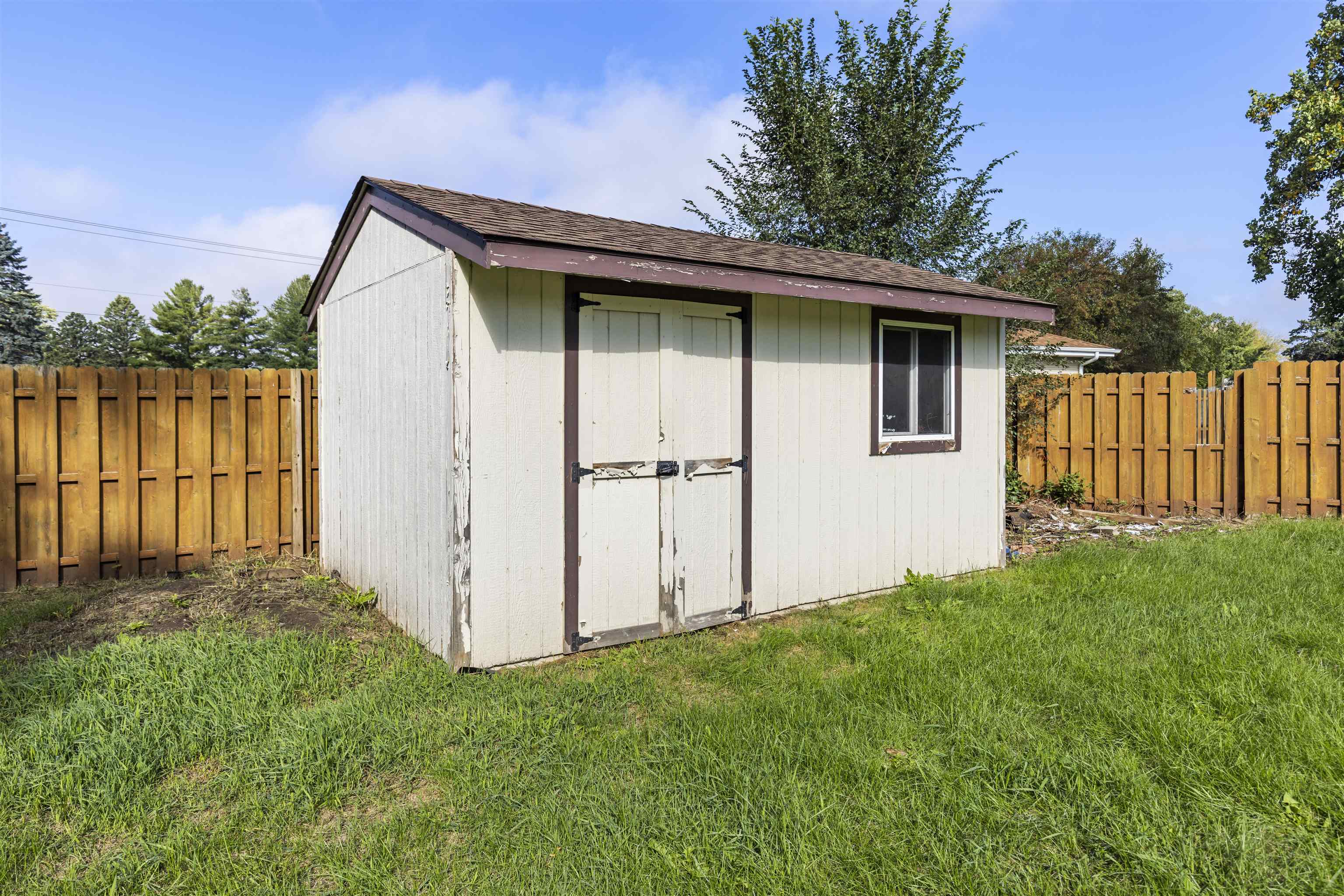 4031 Fairfax Road Roscoe, IL 61073 - Photo 23 of 23 a view of backyard with large trees and a wooden fence