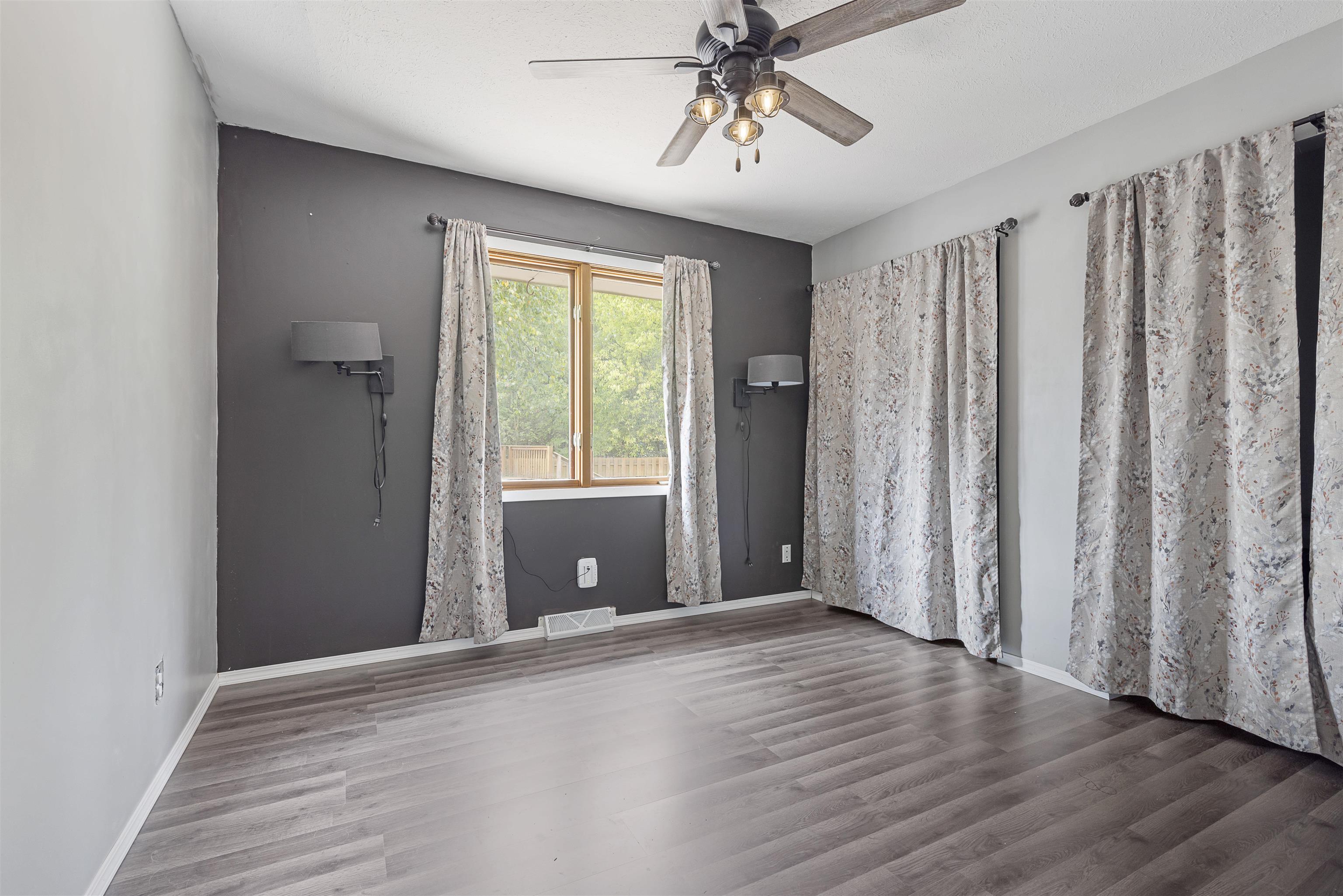 4031 Fairfax Road Roscoe, IL 61073 - Photo 9 of 23 a view of an empty room with a window and wooden floor