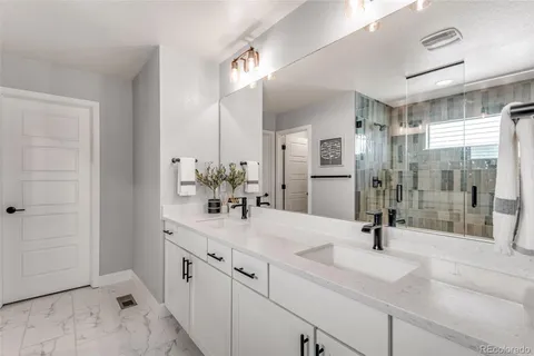 a bathroom with a shower sink and mirror