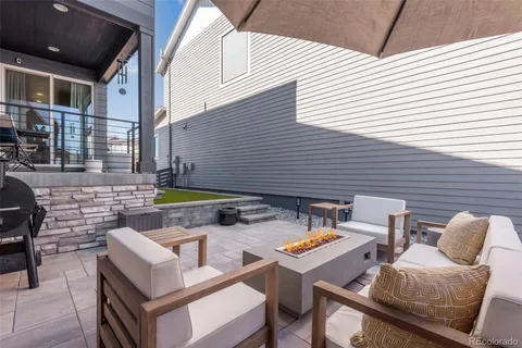 a view of backyard with a seating space