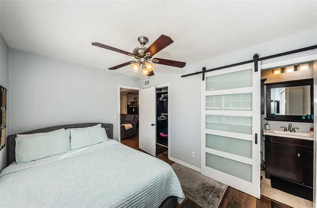 a bedroom with a bed and a chandelier