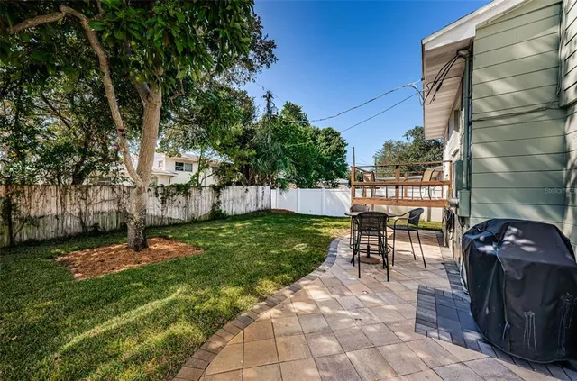 a view of a patio with table and chairs and potted plants
