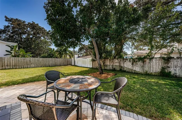 a view of a house with sitting area and garden