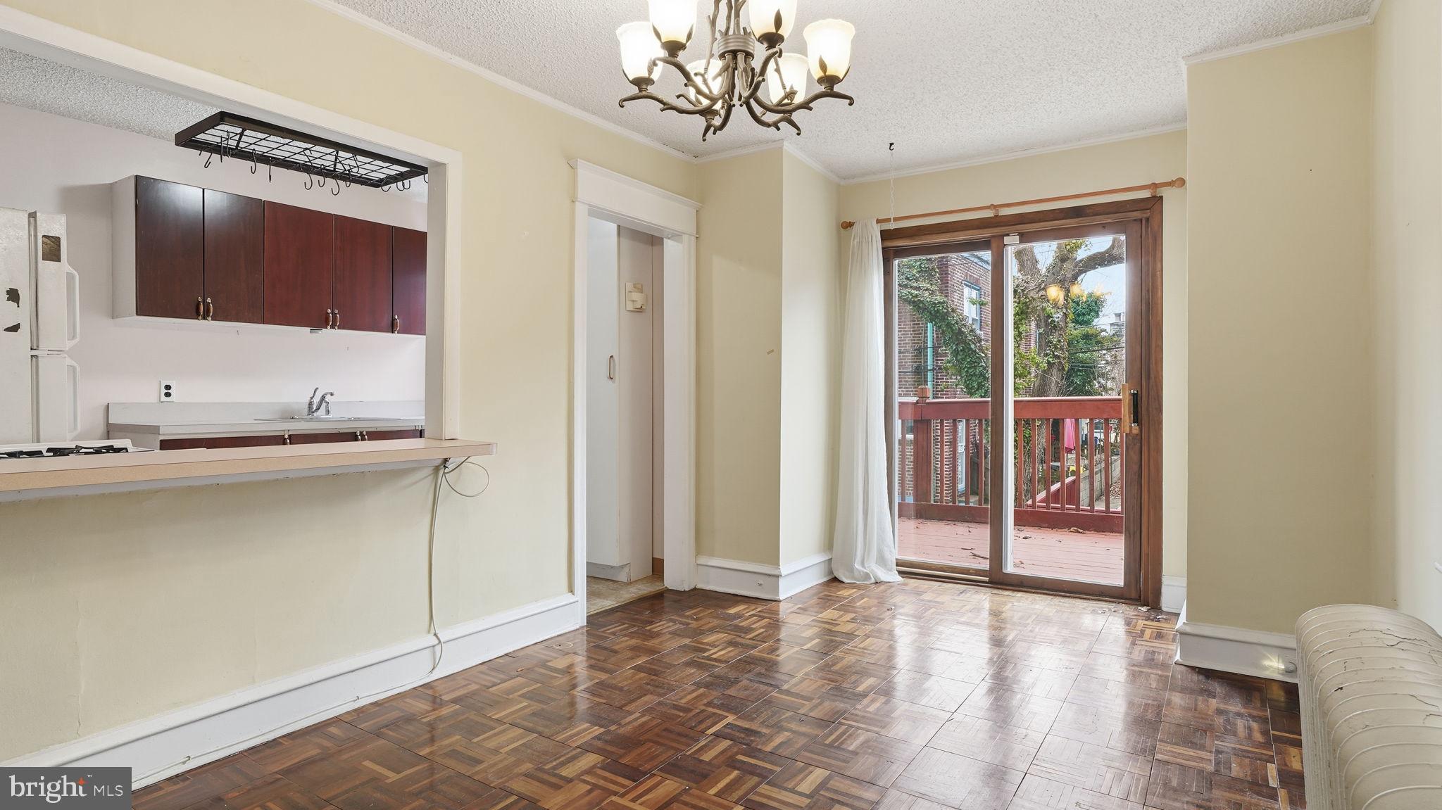 442 Wellesley Road Philadelphia, PA 19119 - Photo 13 of 36 a view of a hallway with wooden floor and a chandelier