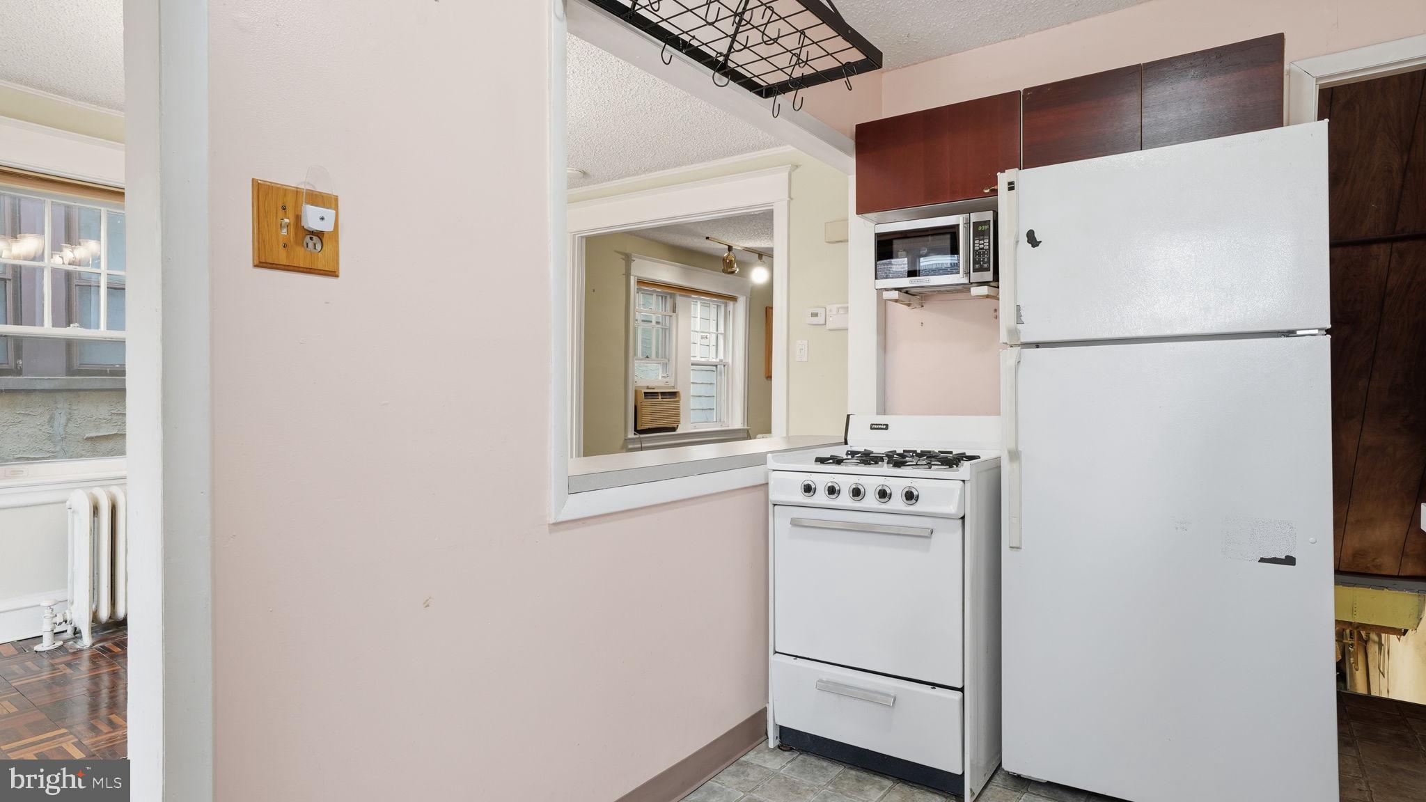442 Wellesley Road Philadelphia, PA 19119 - Photo 17 of 36 a white refrigerator freezer and a stove sitting inside of a kitchen