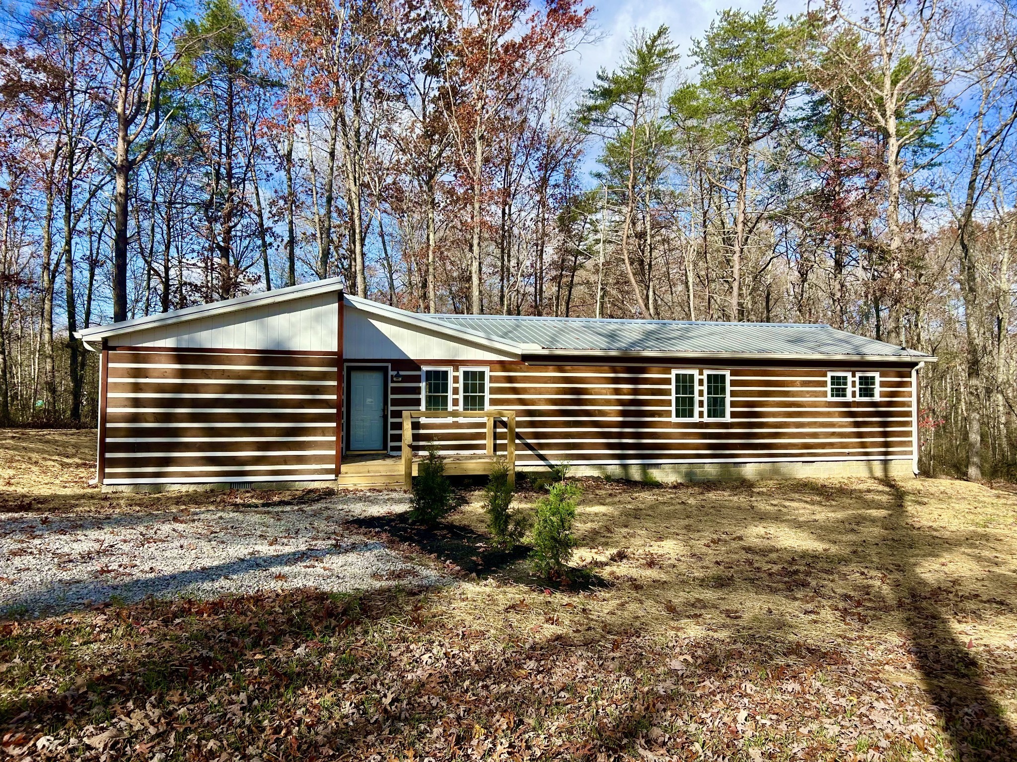 a side view of a house with a yard