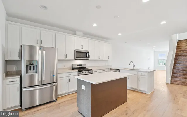 a kitchen with stainless steel appliances a refrigerator stove microwave and cabinets