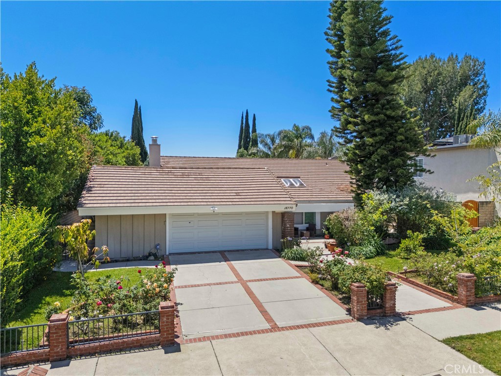 18770 Tribune Street Porter Ranch, CA 91326 - Photo 1 of 30 a front view of a house with a garden