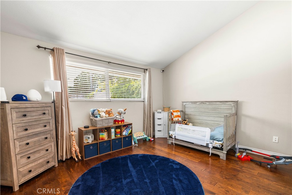 18770 Tribune Street Porter Ranch, CA 91326 - Photo 13 of 30 a bedroom with furniture and a wooden floor