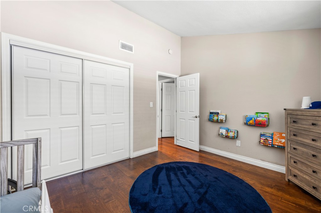 18770 Tribune Street Porter Ranch, CA 91326 - Photo 14 of 30 a bedroom with a bed and a dresser