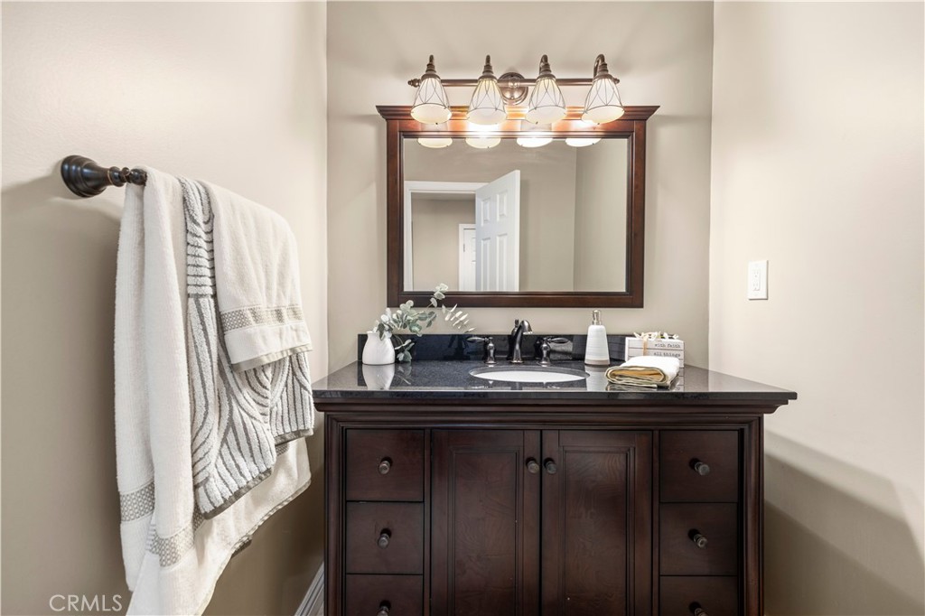 18770 Tribune Street Porter Ranch, CA 91326 - Photo 17 of 30 a bathroom with a sink and a mirror