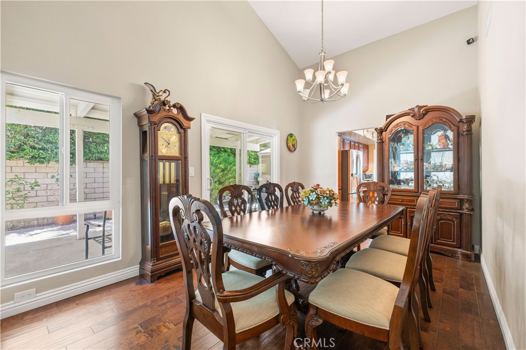18770 Tribune Street Porter Ranch, CA 91326 - Photo 6 of 30 a view of a dining room with furniture a chandelier and wooden floor