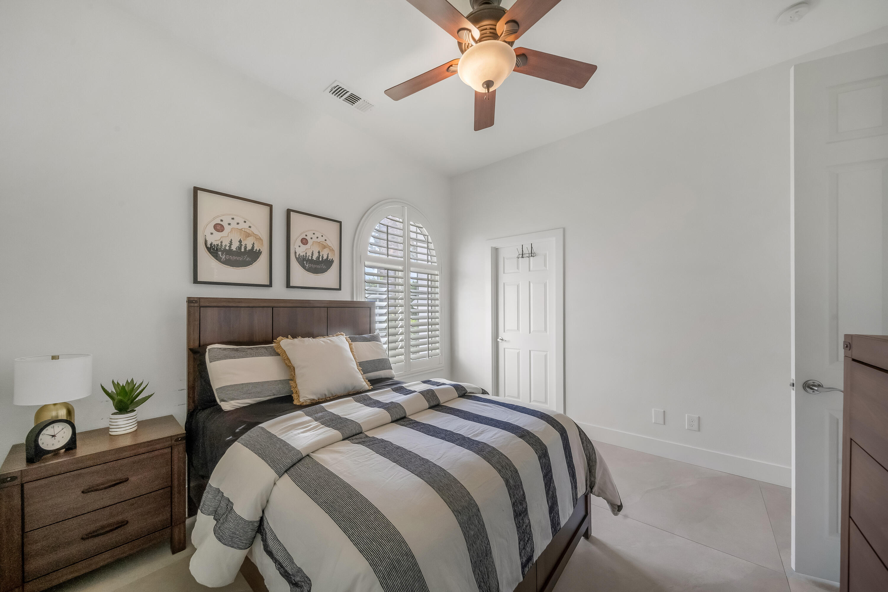 80262 Amazon Avenue Indio, CA 92201 - Photo 34 of 69 a bedroom with a bed and a chandelier