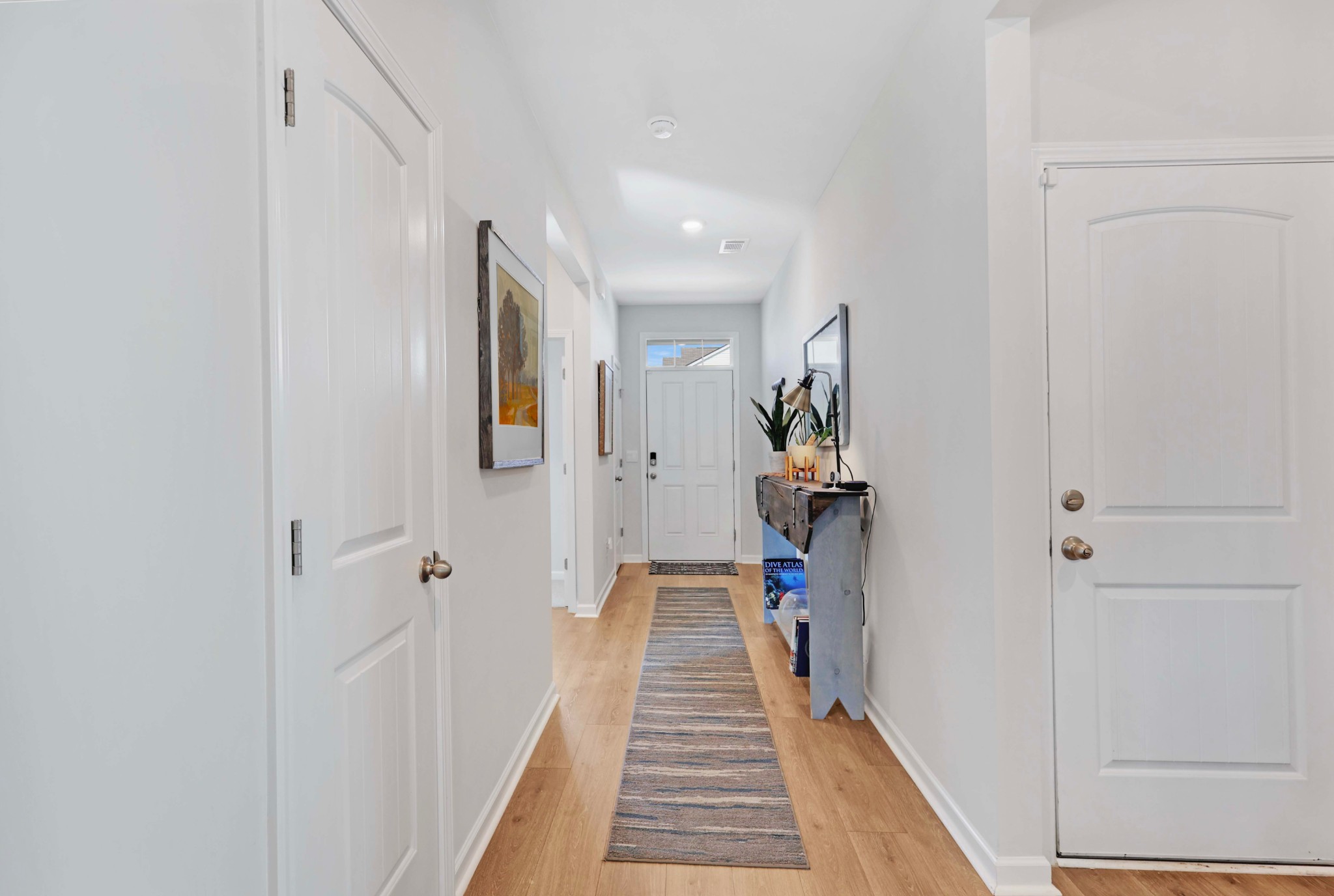 7764 Stapleton Chase Drive Antioch, TN 37013 - Photo 29 of 31 a view of a hallway with wooden floor and stairs