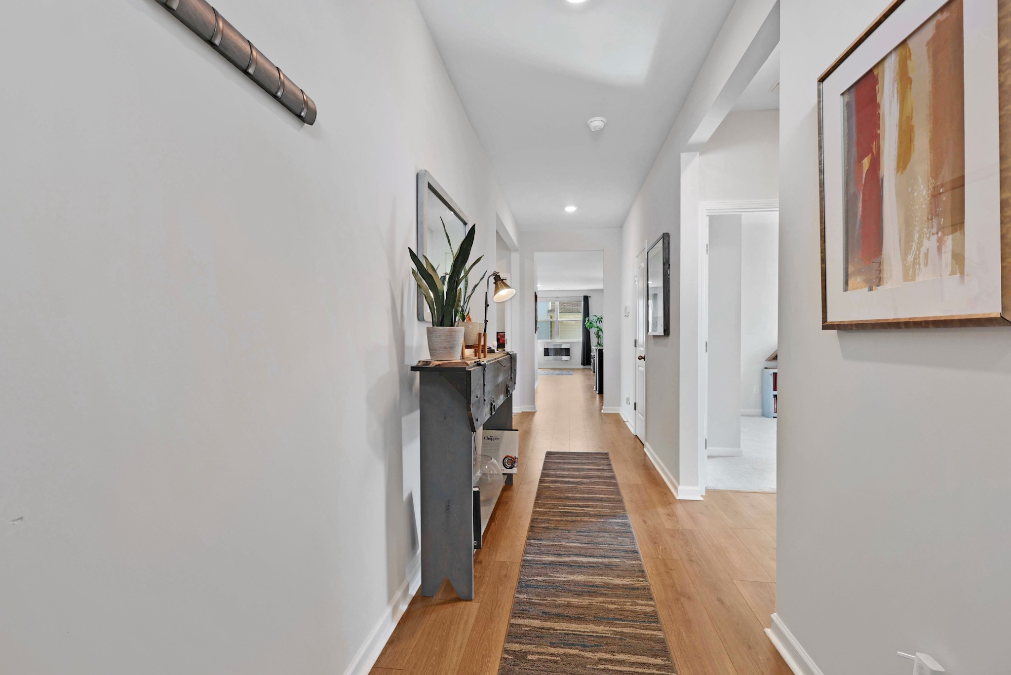 7764 Stapleton Chase Drive Antioch, TN 37013 - Photo 4 of 31 a view of a hallway with wooden floor and staircase