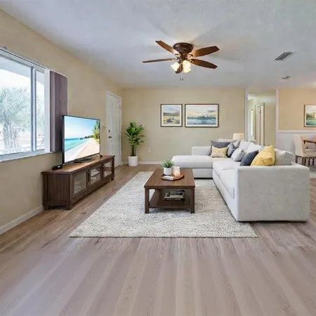 a living room with furniture and a flat screen tv